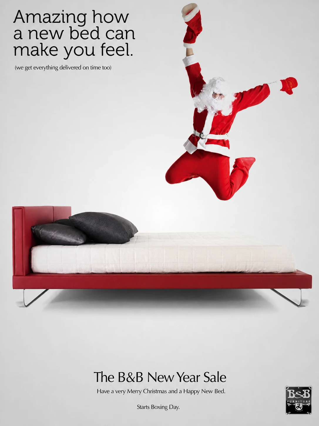 B&B Furniture advert with Santa leaping above a red bed and the headline Amazing how a new bed can make you feel