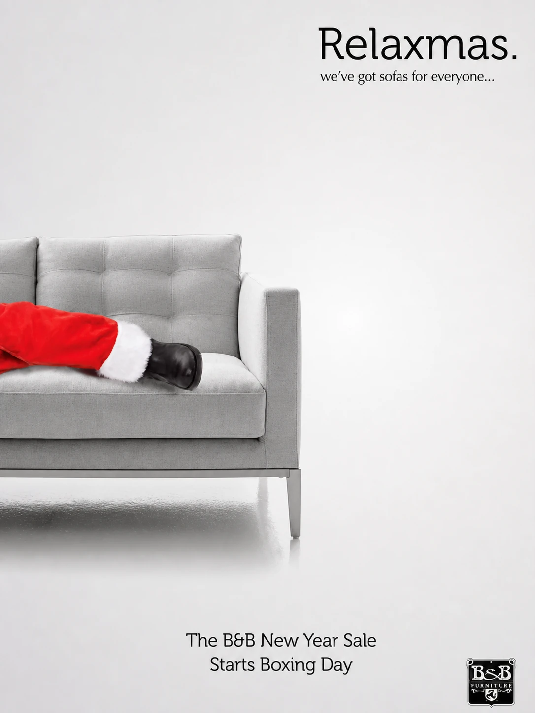 B&B Furniture Relaxmas advert with Santa resting across a grey sofa