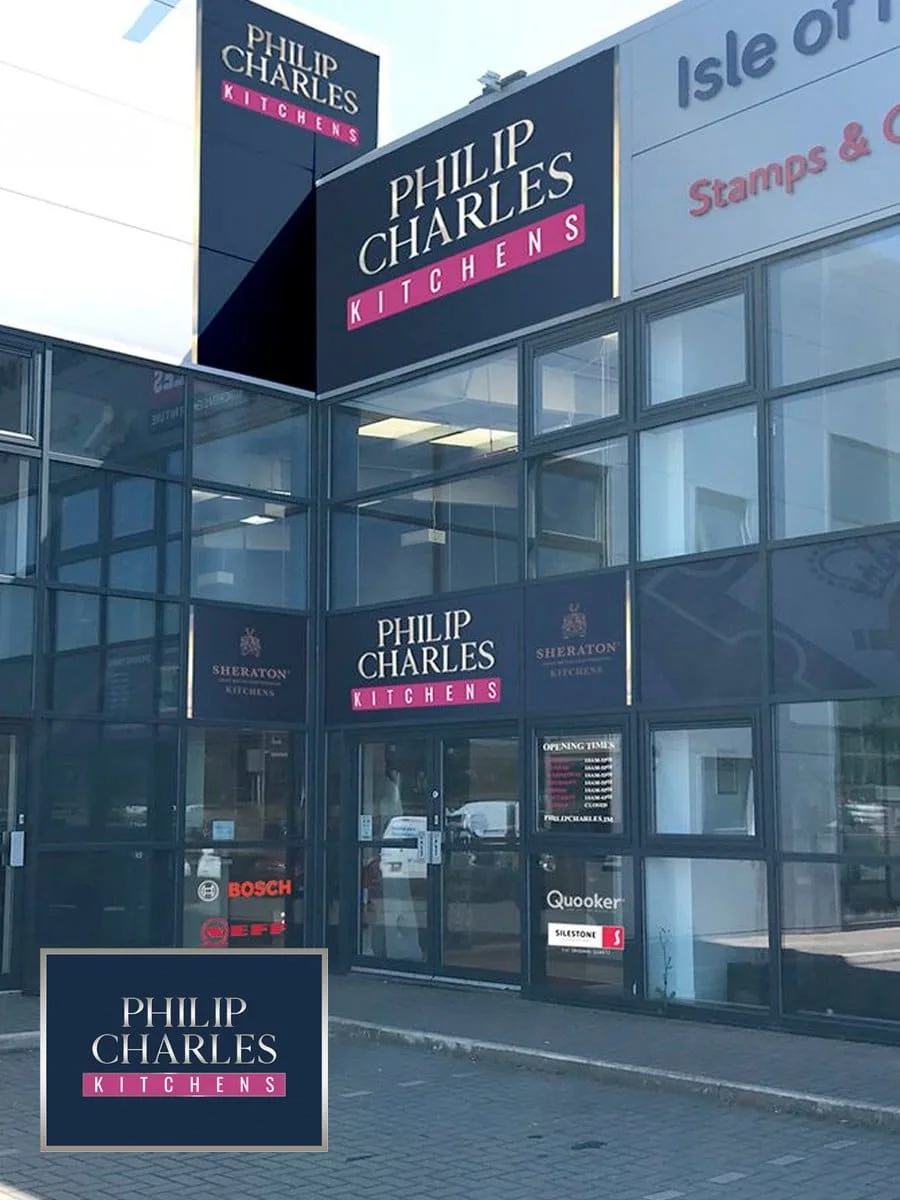 The completed Philip Charles Kitchens building exterior with navy and magenta vinyl graphics